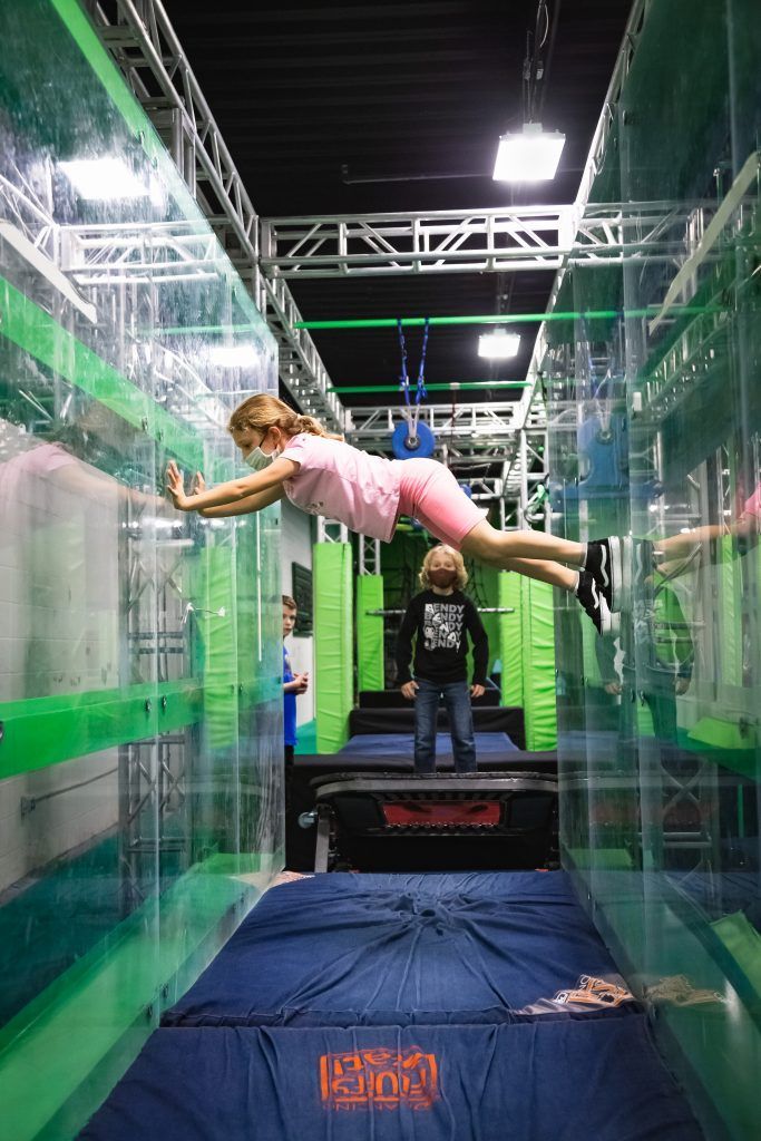 Young girl suspended between two walls