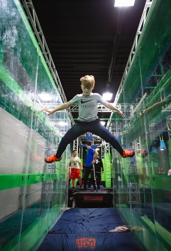 Boy climbing between two walls