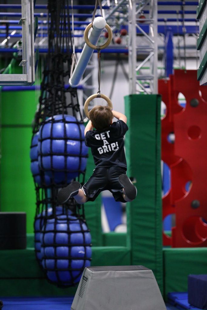 Young boy swinging on ring 