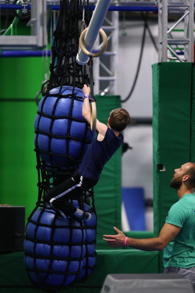 Young boy climbing rope