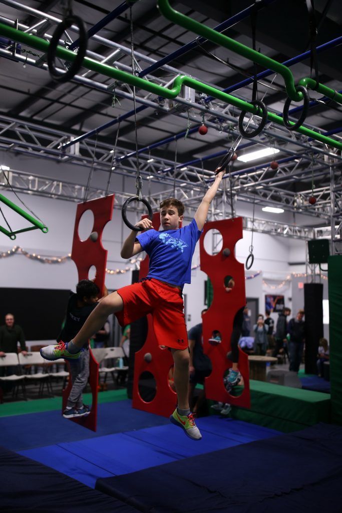 Boy traversing rings