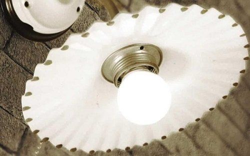 una lampadina accesa di un lampadario bianco