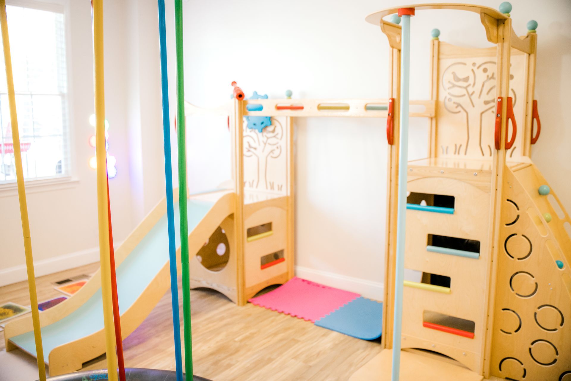 A wooden playground slide and other play equipment.