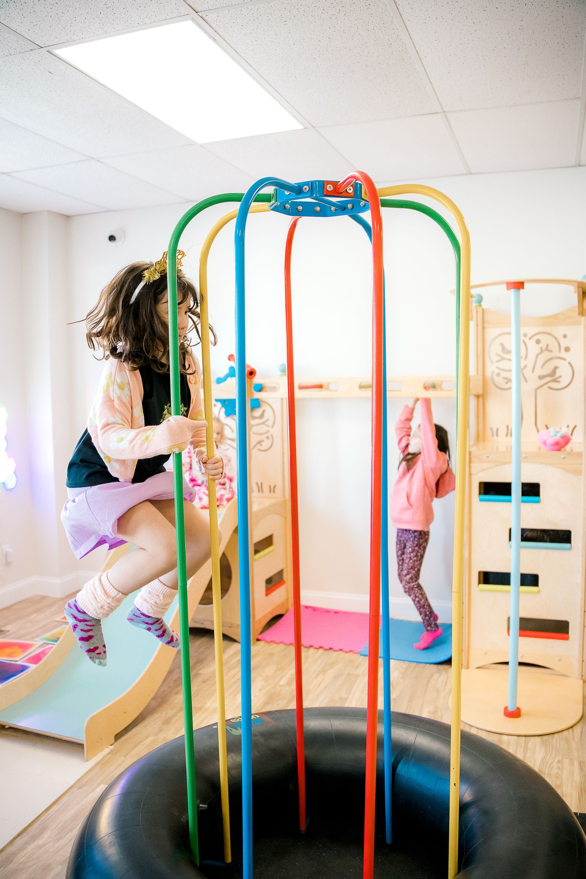 Two little girls are playing in a playground.