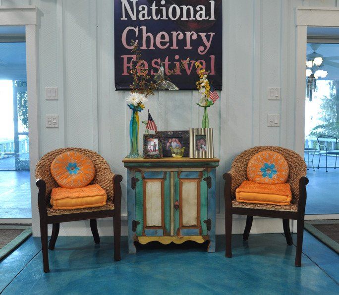 Two chairs in front of a sign that says national cherry festival