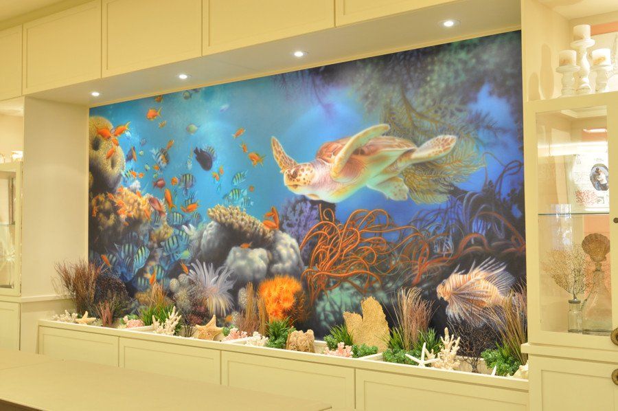 There is a painting of a sea turtle on the wall.