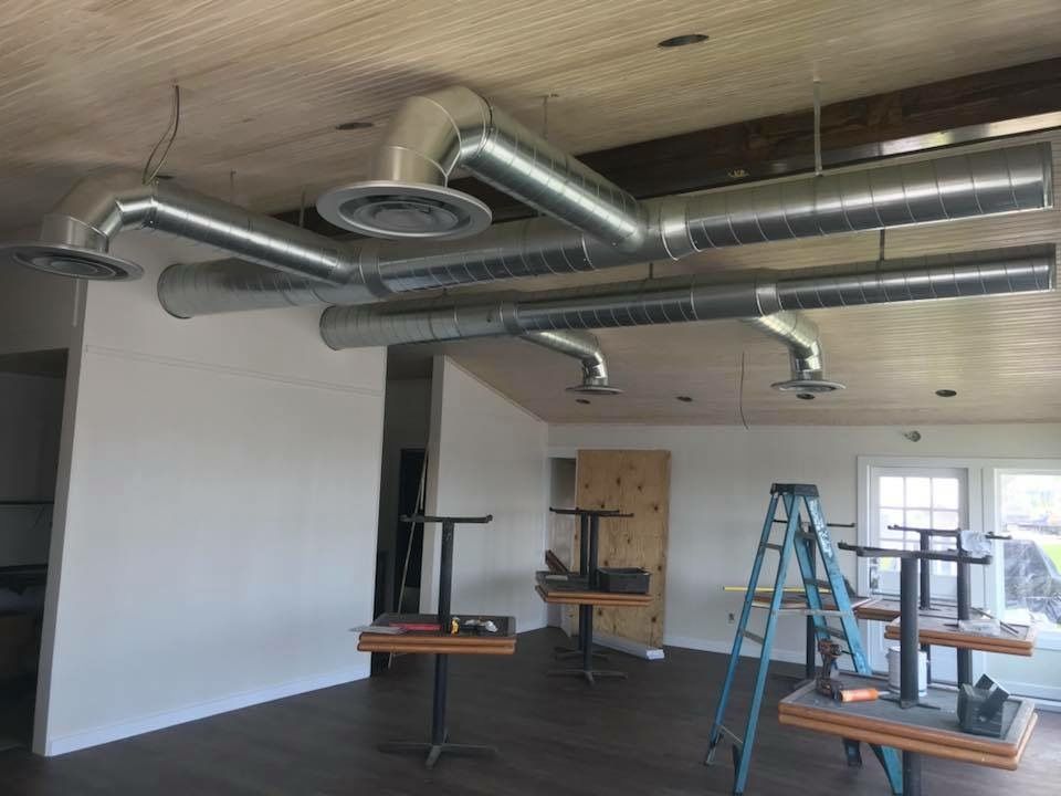 A room with tables and a ladder in it.