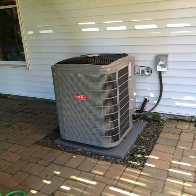 A berkshire air conditioner is sitting on the side of a house