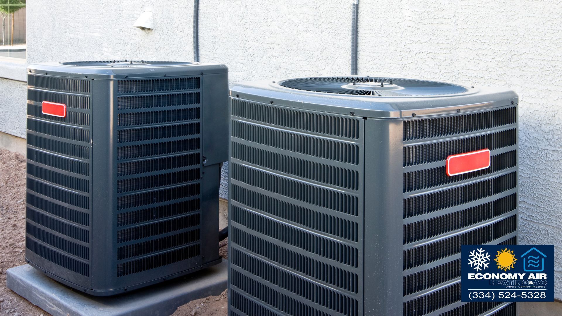 Two air conditioners are sitting next to each other in front of a building.