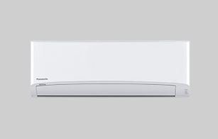 A white air conditioner is sitting on a white surface.