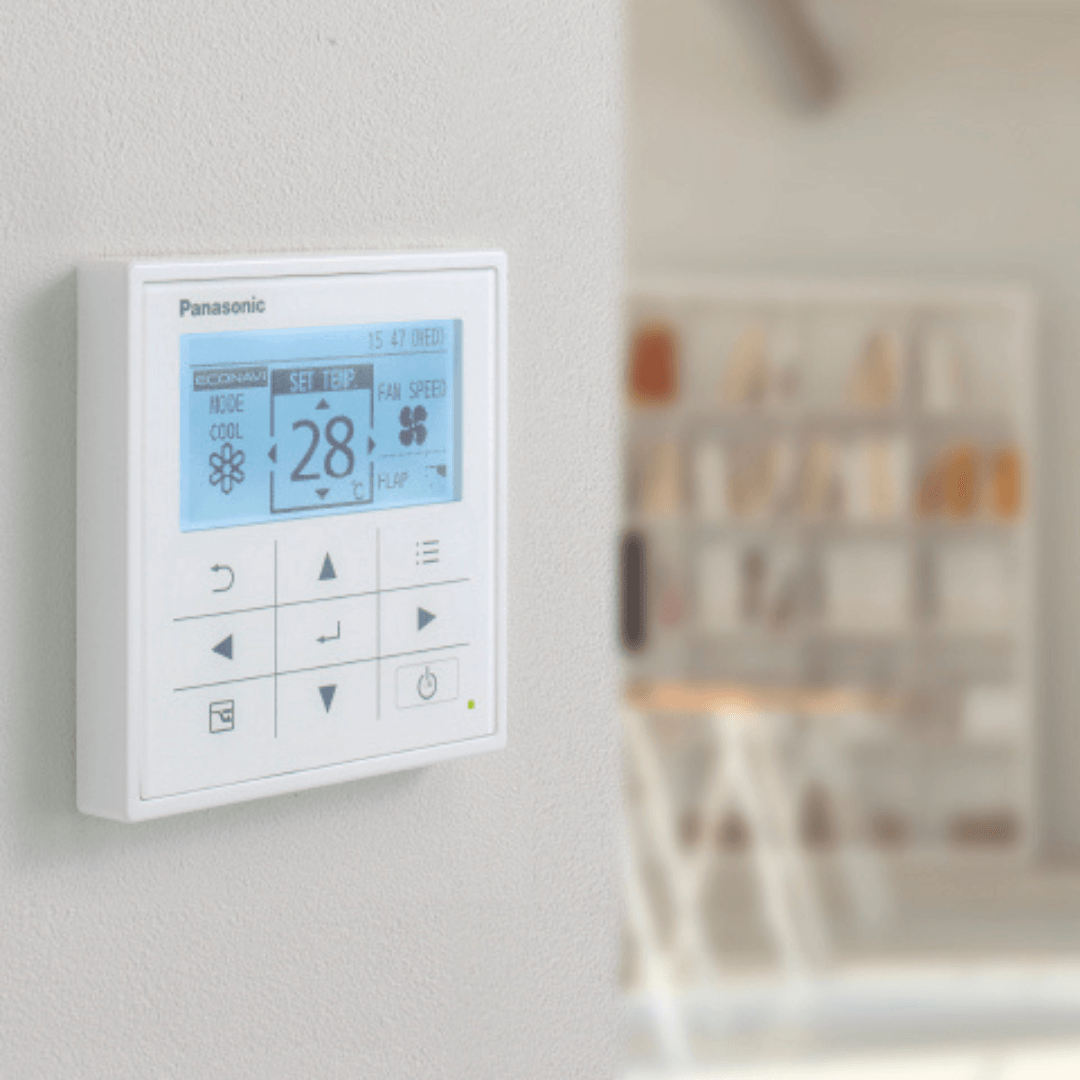 A panasonic thermostat is mounted on a wall