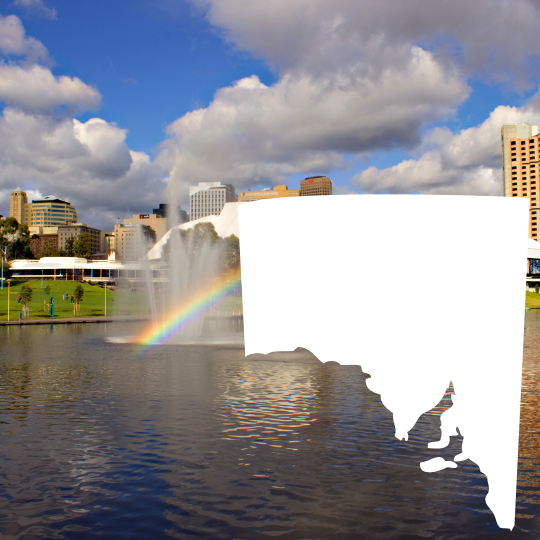 A silhouette of a city with a fountain and a rainbow