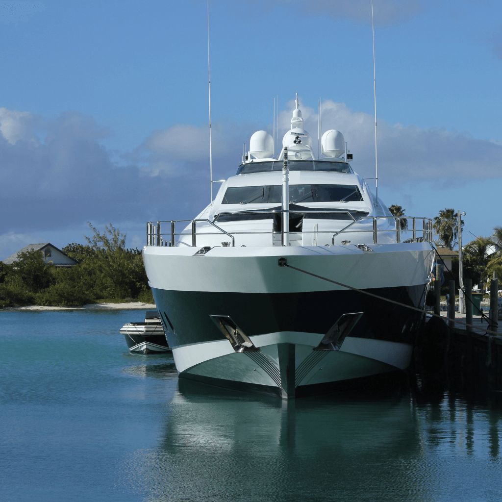 A large white and black yacht is docked in the water