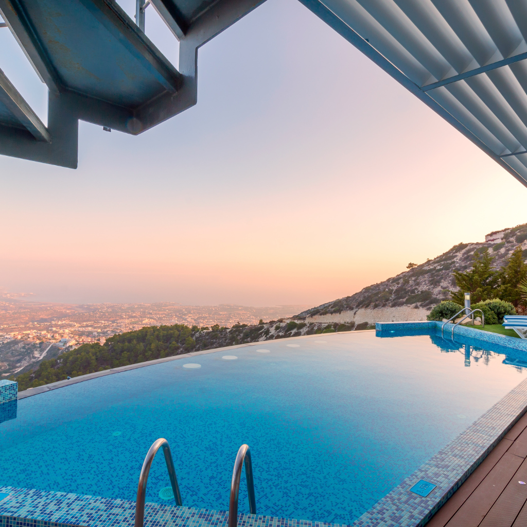 A swimming pool with a view of a city and mountains