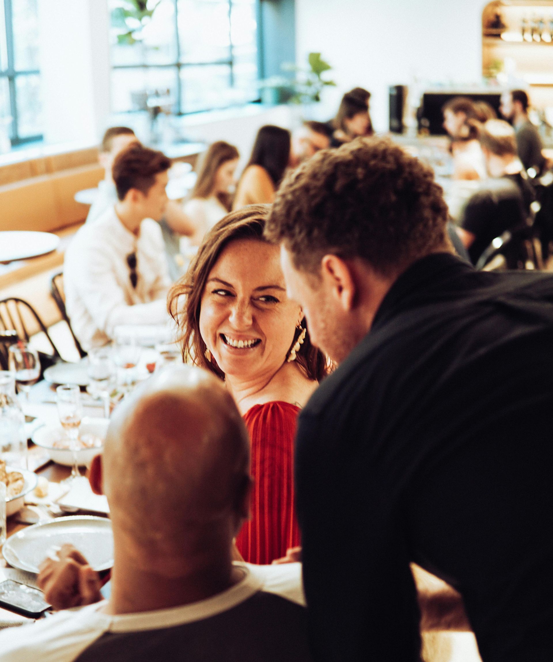 A man and a woman are sitting at a table in a restaurant