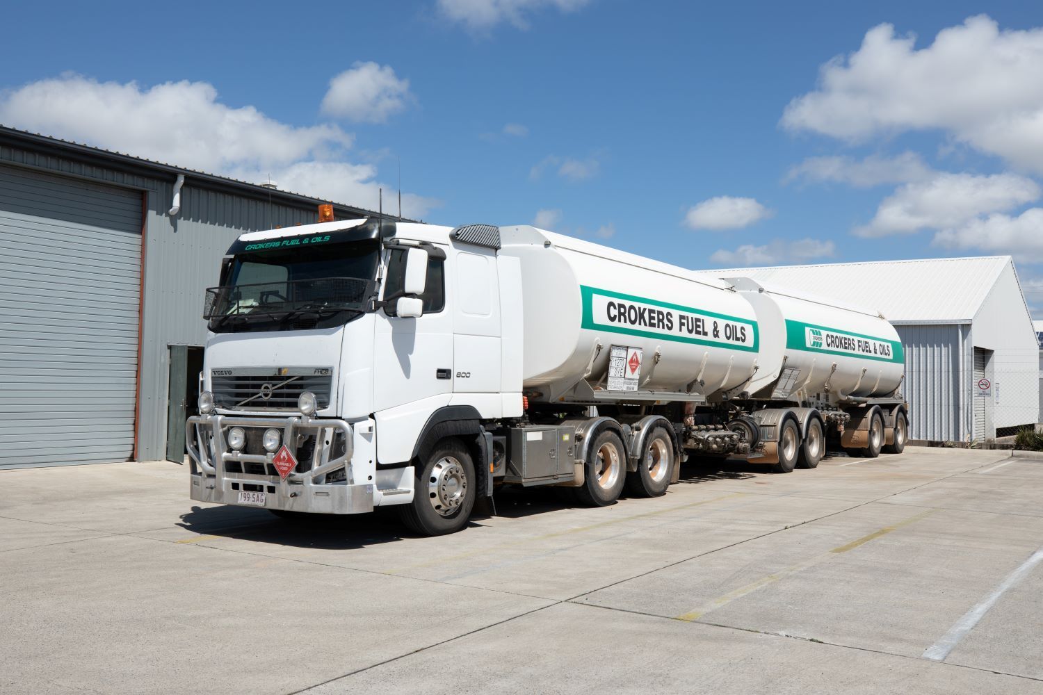 A White Fuel Truck is Parked in Front of a Building — Crokers Fuel & Oils Pty Ltd in Paget, QLD