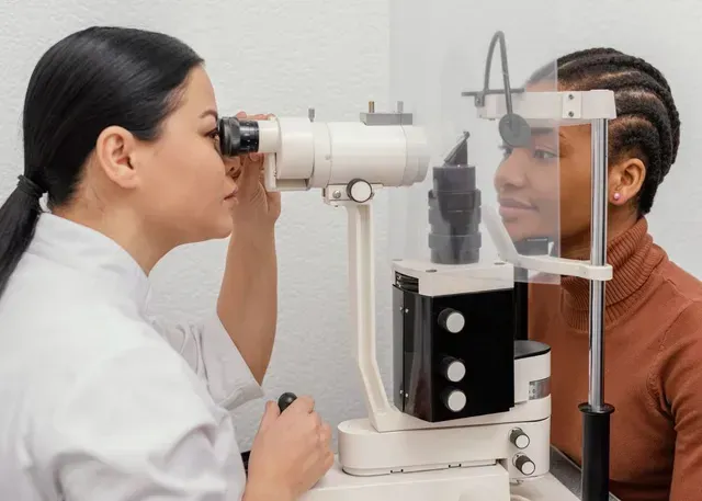 A woman is getting her eyes examined by an ophthalmologist.