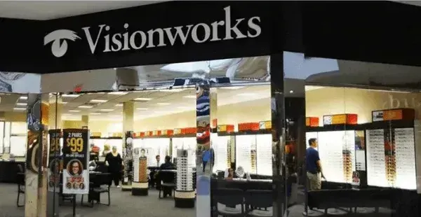 A visionworks store in a mall with people inside