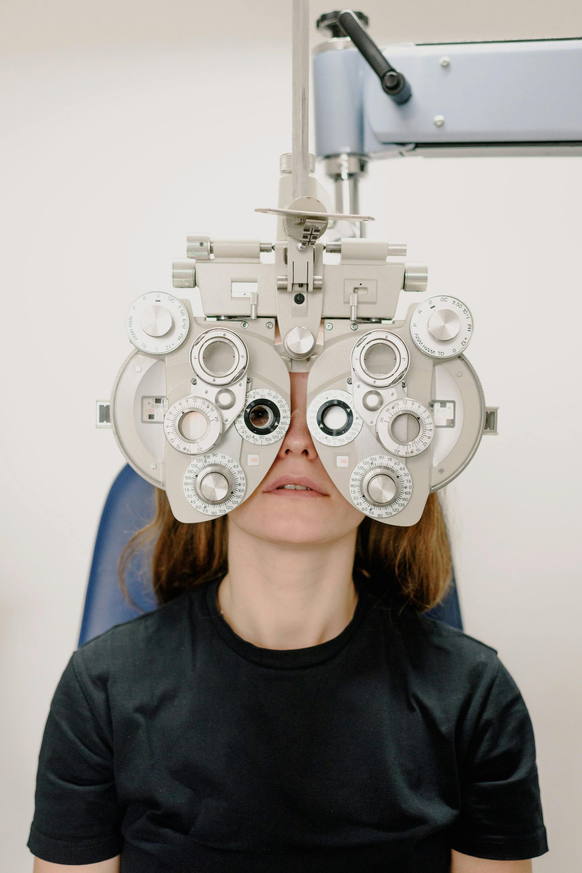A woman is getting her eyes examined by an ophthalmologist.