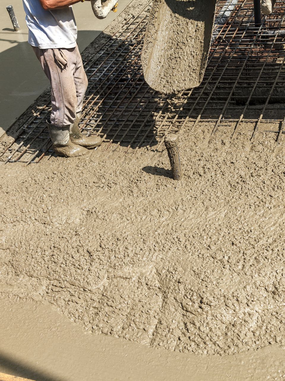 pouring concrete into the construction- of the house