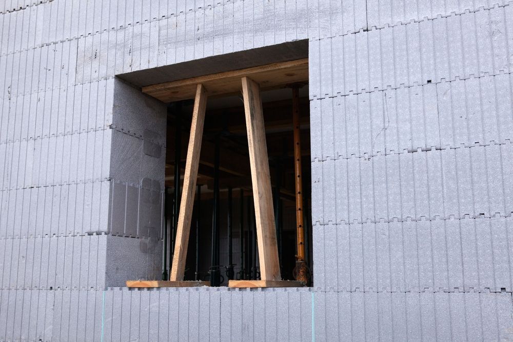 A window is being built into the side of a building.