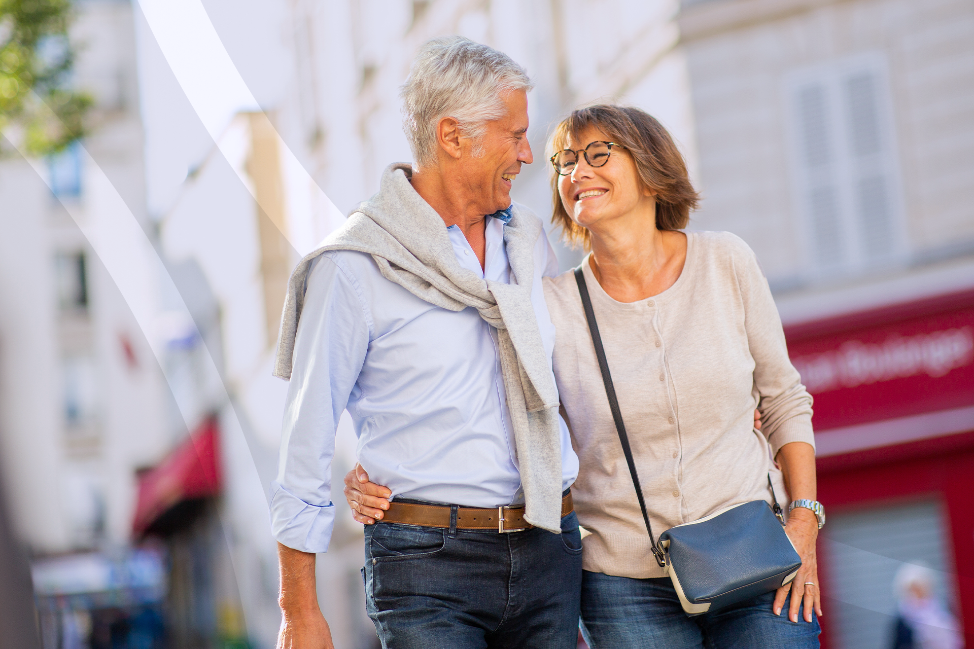 A man and a woman are walking down a city street.