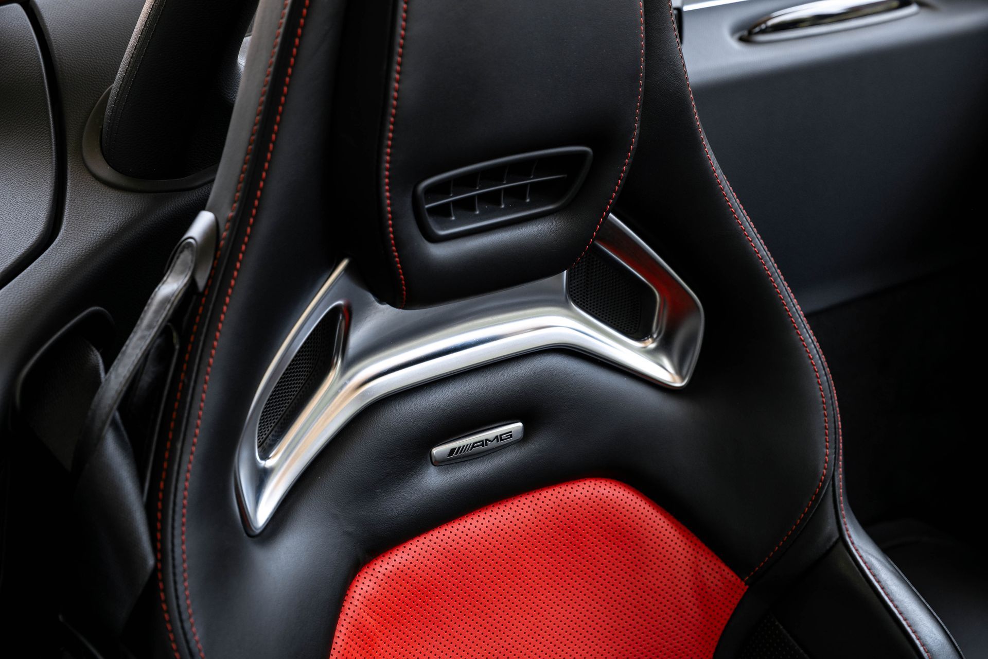 Black and red car seat with silver accents and