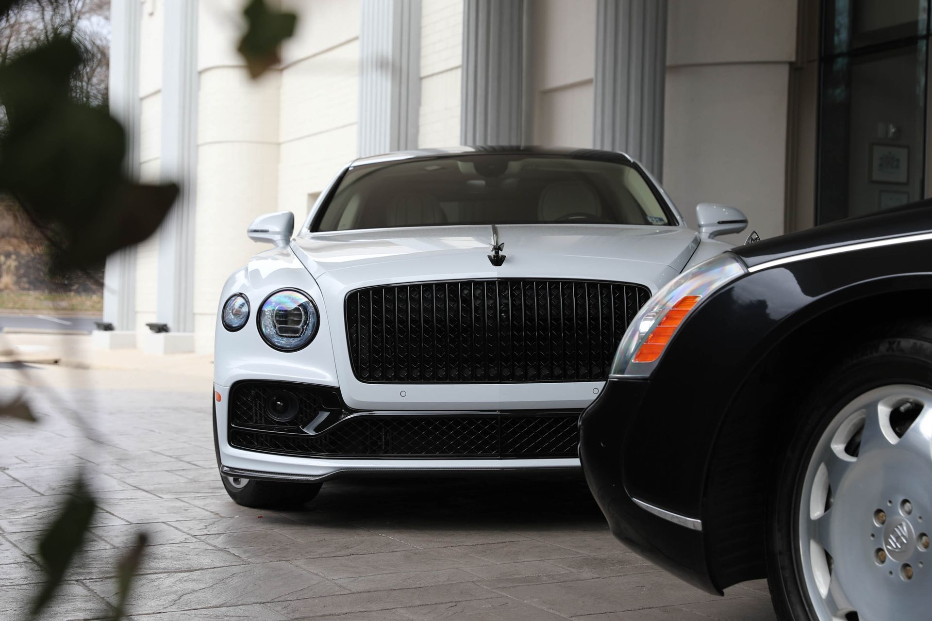 front of a Bentley Flying Spur luxury car photo opportunities