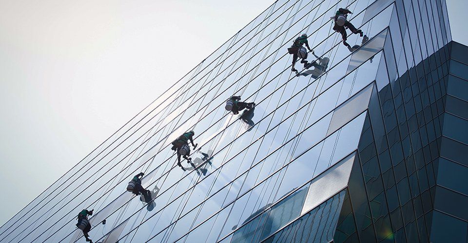 set of experts cleaning a high rise building