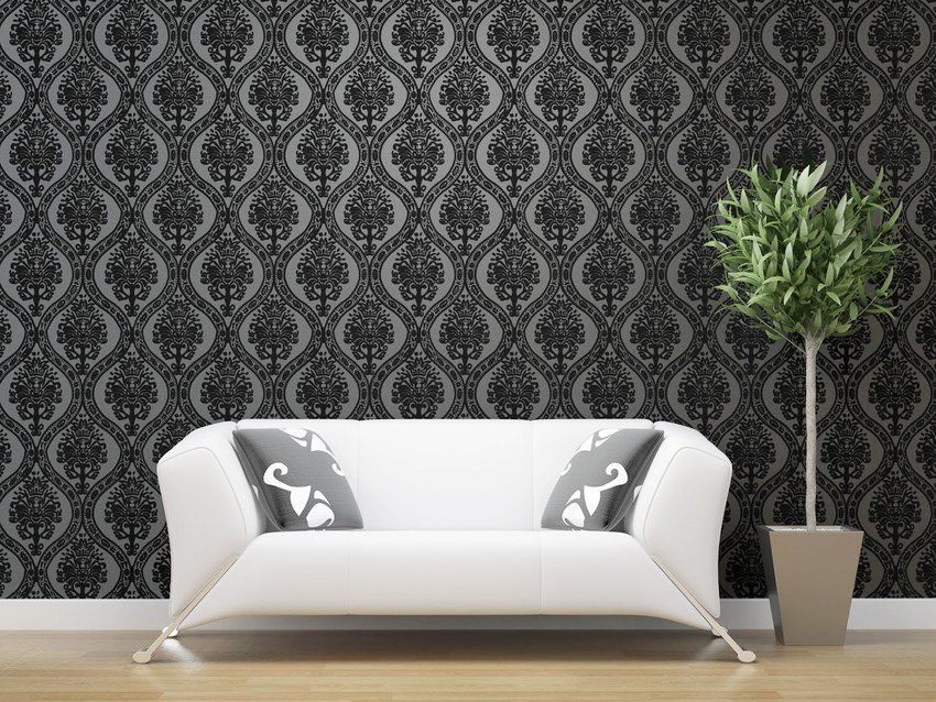Black and grey feature wall with sofa in centre of image