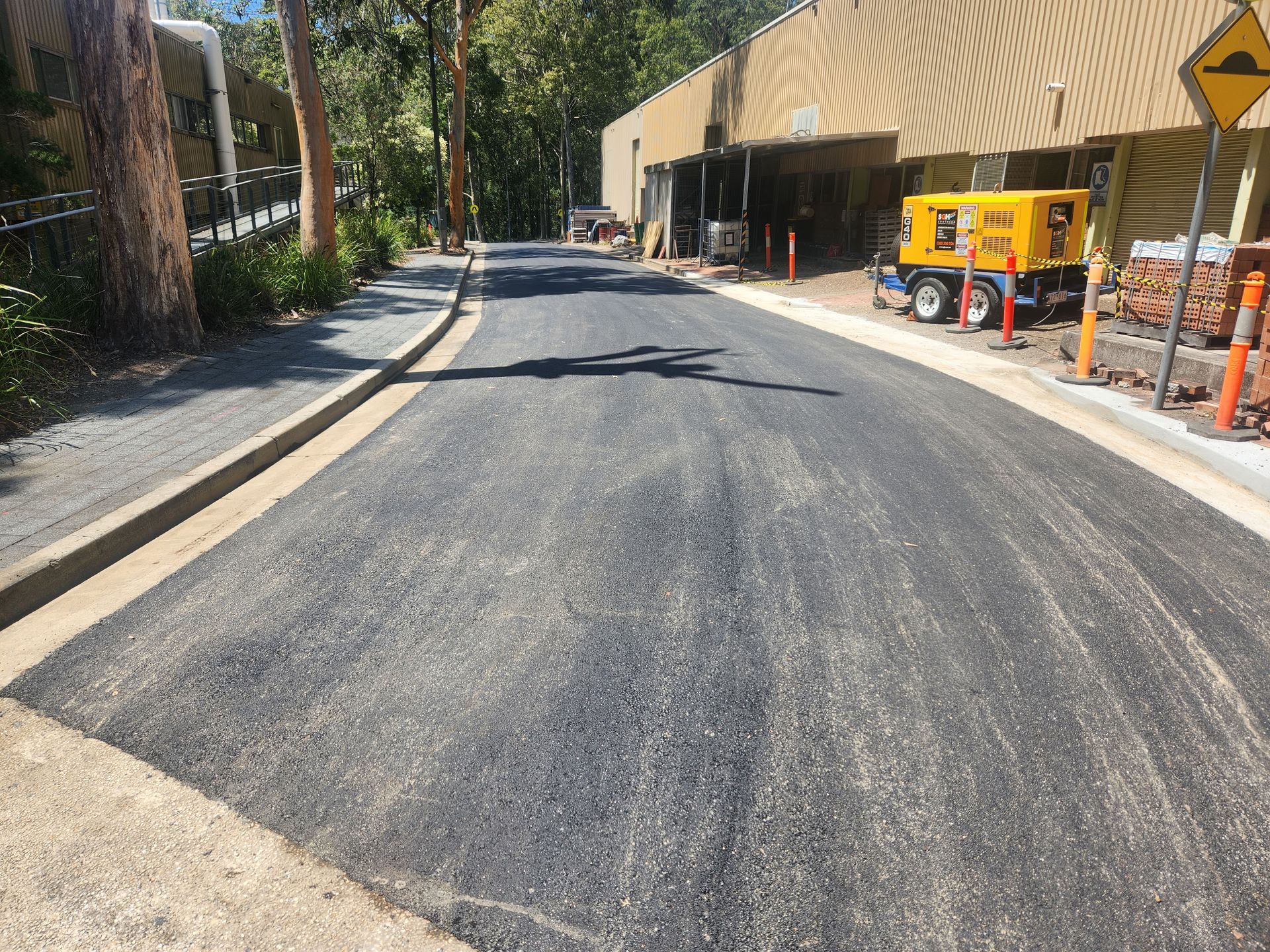 Newly Paved Asphalt Road With Concrete Borders — TAC Asphalt Services in Warners Bay, NSW