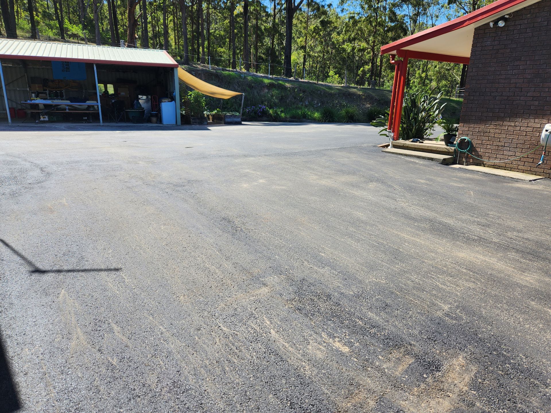 Gravel Driveway Leading To A Building With A Red-roofed Carport — TAC Asphalt Services in Warners Bay, NSW