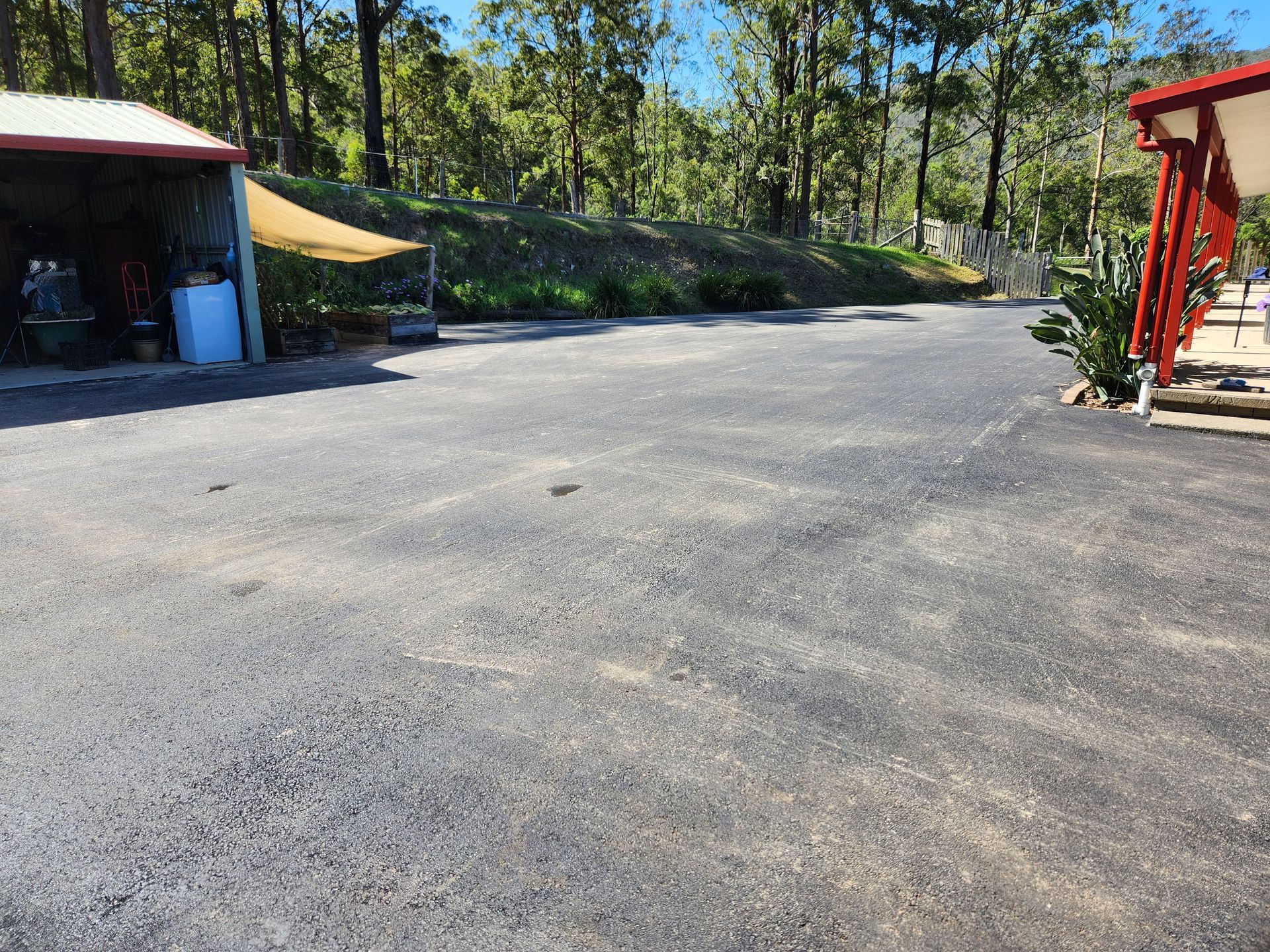 Asphalt Driveway In Front Of A Shed And House — TAC Asphalt Services in Warners Bay, NSW