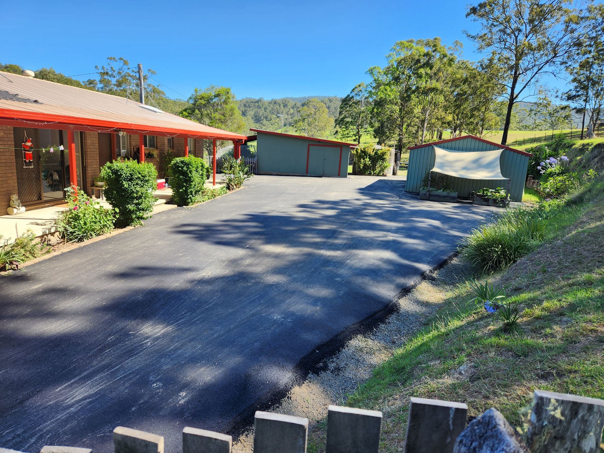 Paved Driveway Leading To A House With Two Sheds — TAC Asphalt Services in Warners Bay, NSW