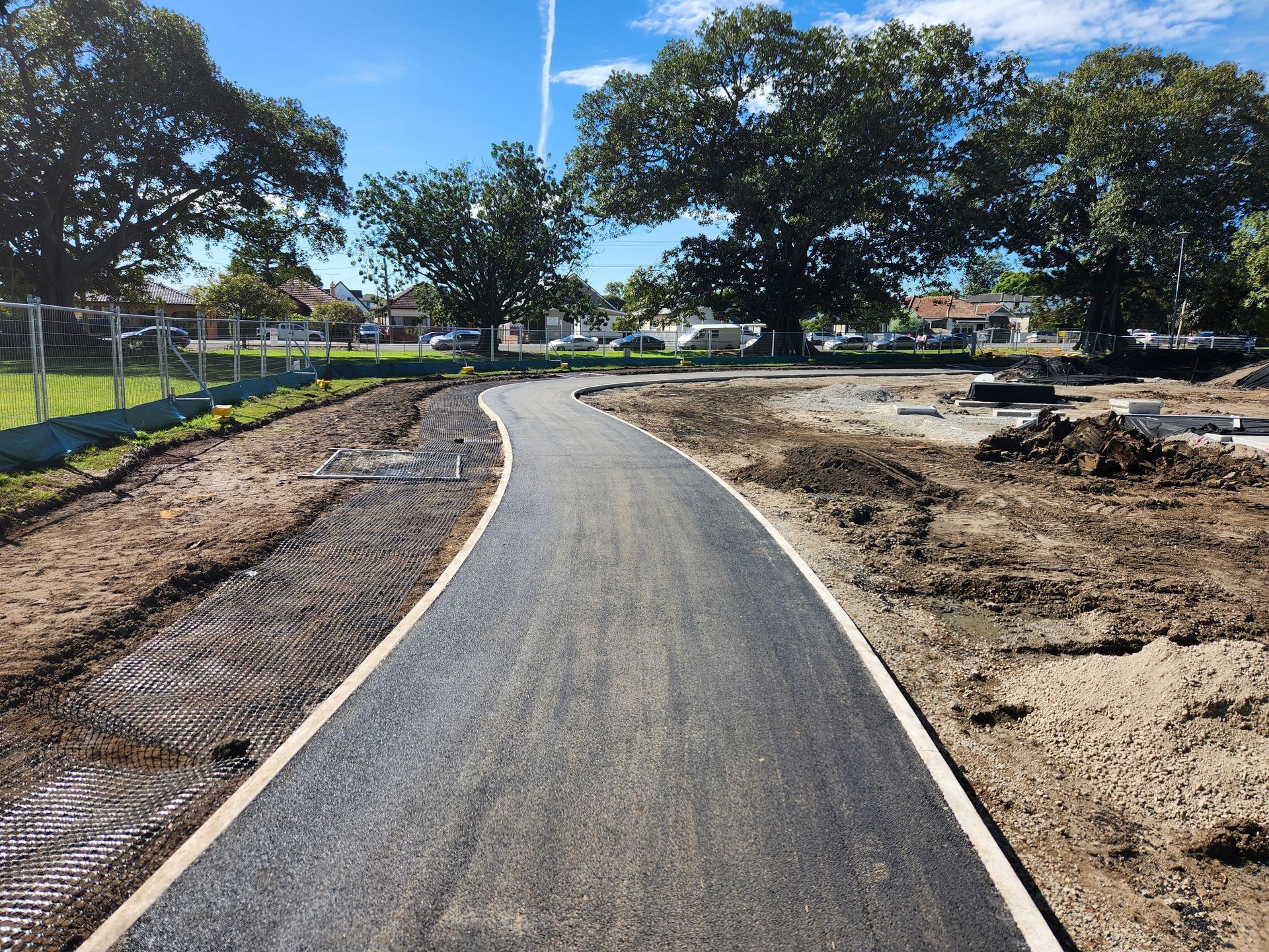 Newly Paved Pathway Curves Through a Dirt Area Trees in Background — TAC Asphalt Services in Hunter Valley, NSW