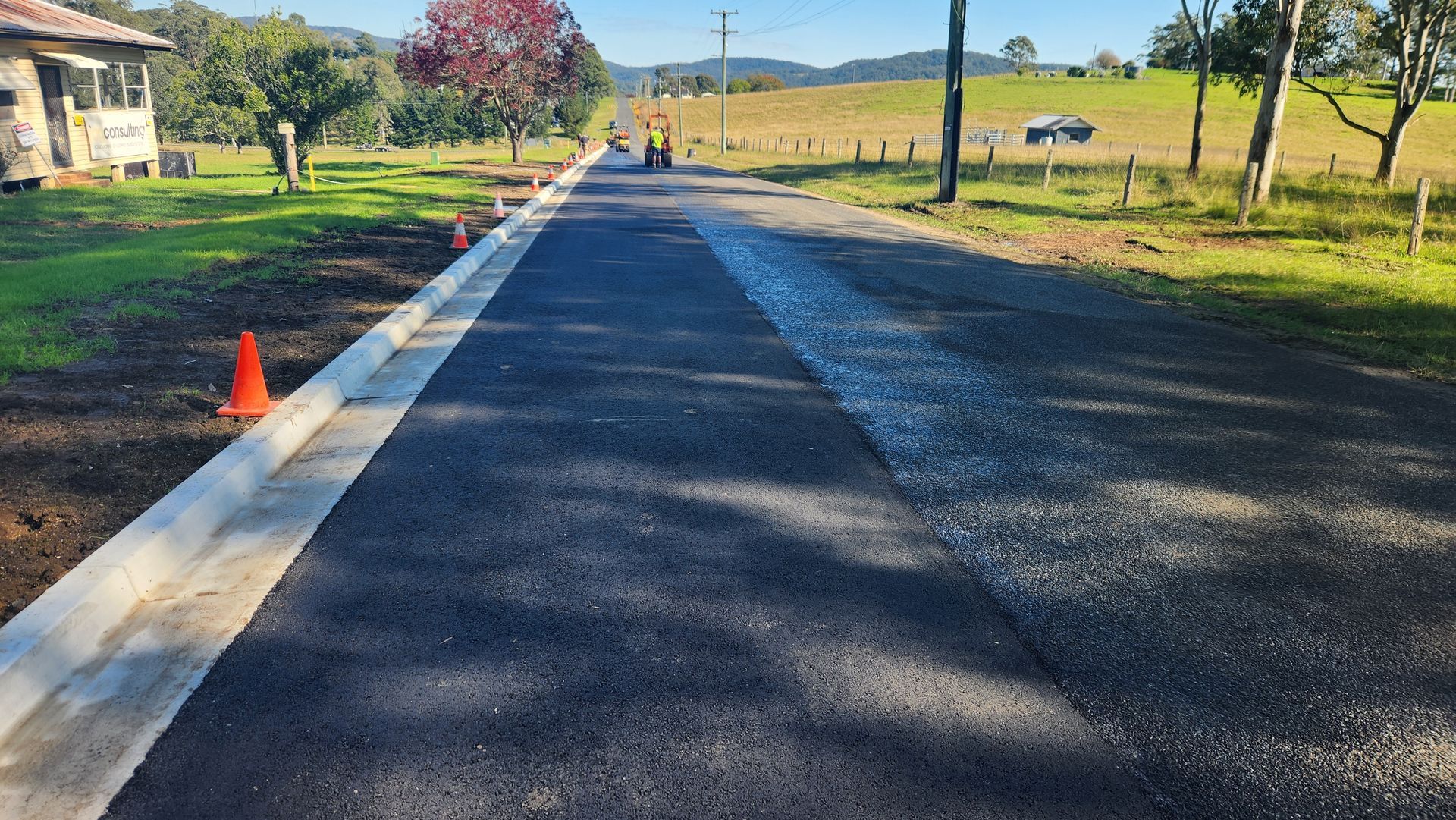Newly Paved Asphalt Road With Concrete Curb — TAC Asphalt Services in Warners Bay, NSW