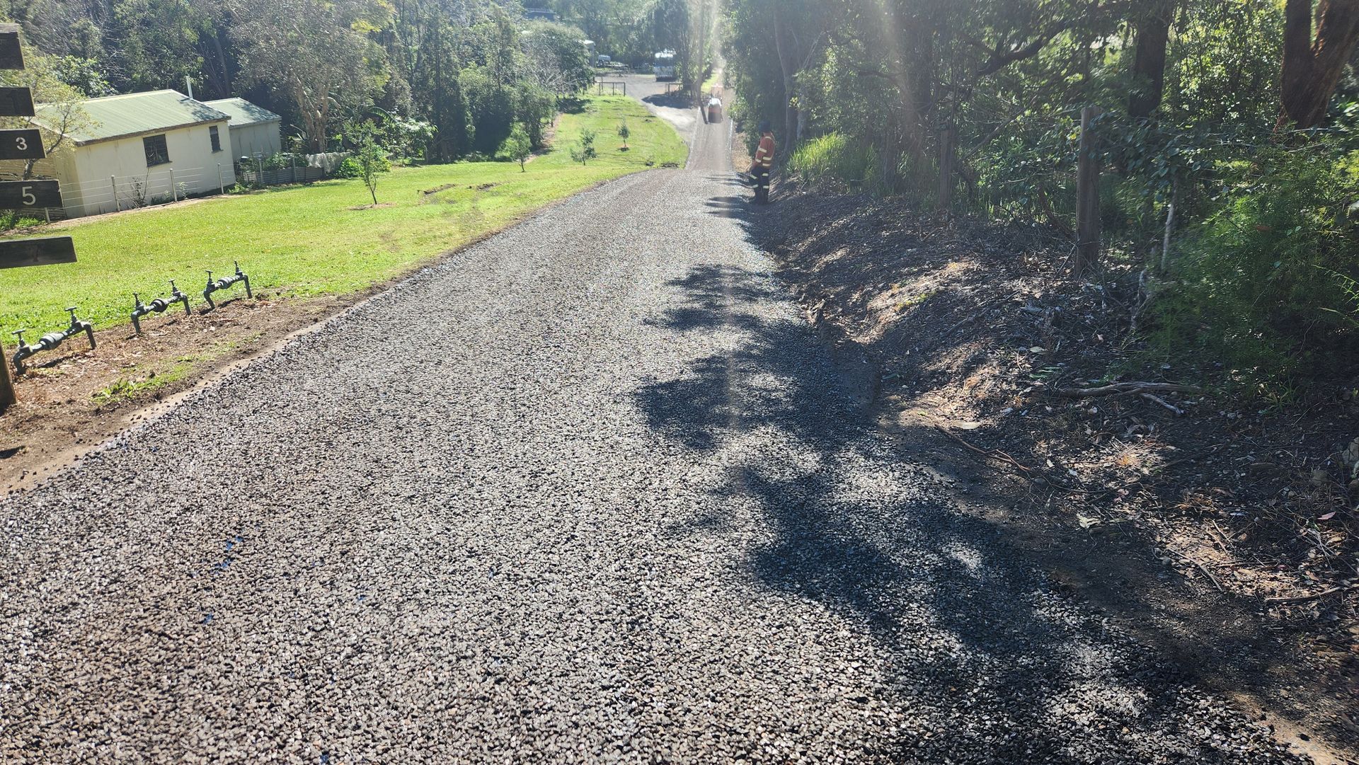 Gravel Driveway Leading Uphill Through A Green — TAC Asphalt Services in Warners Bay, NSW