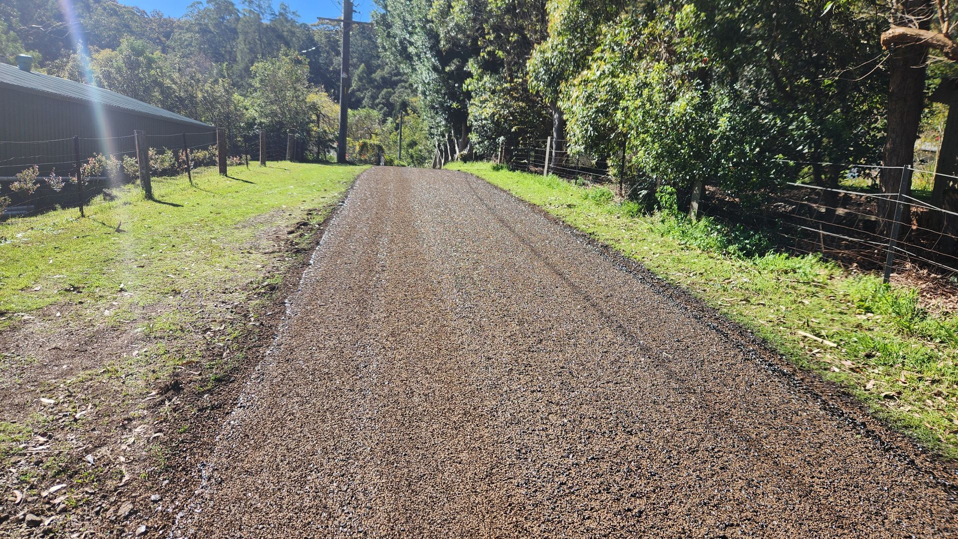Gravel Driveway Leading Into A Green — TAC Asphalt Services in Warners Bay, NSW