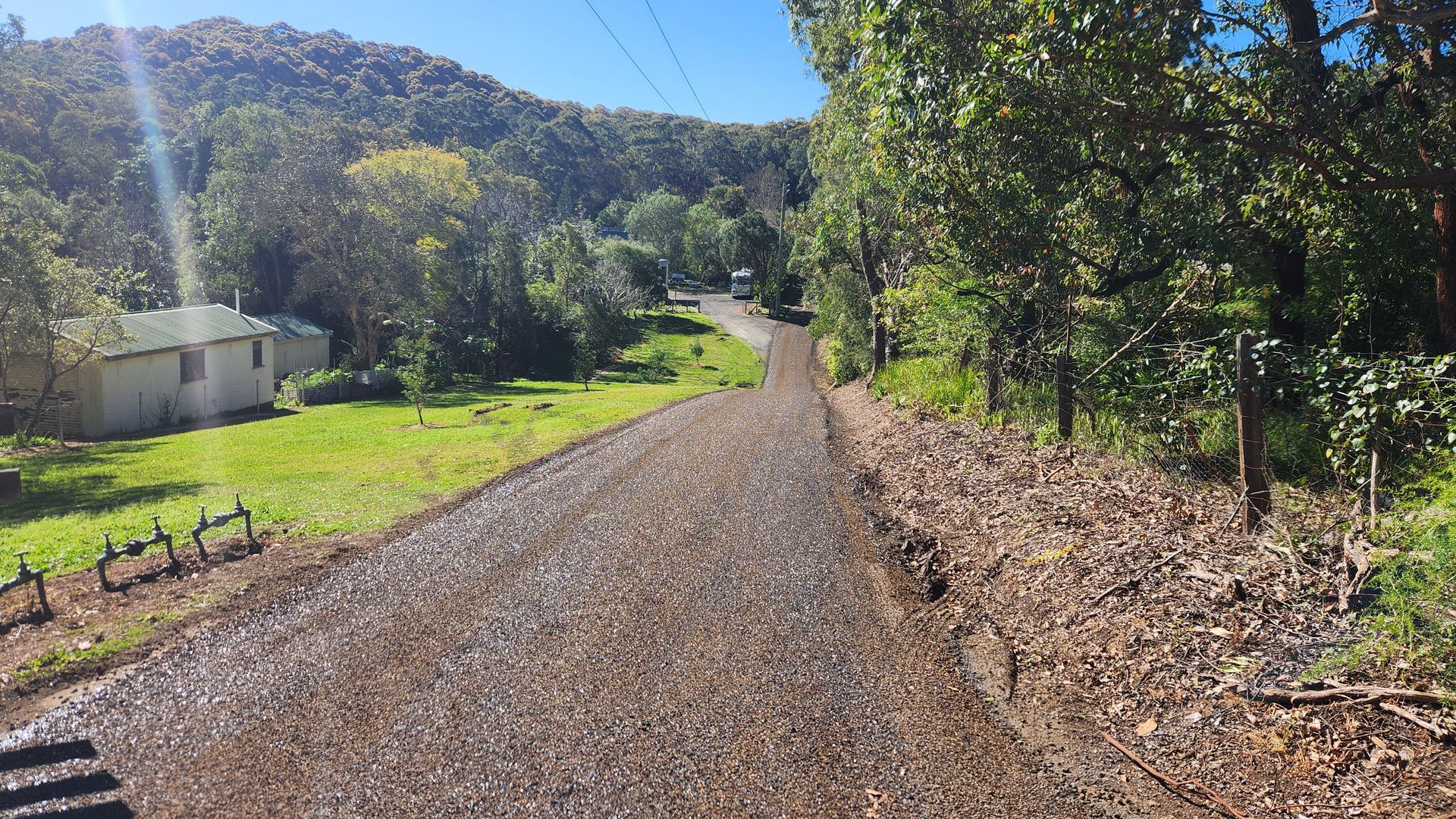Gravel Road Winds Through Green Trees And Hills — TAC Asphalt Services in Warners Bay, NSW