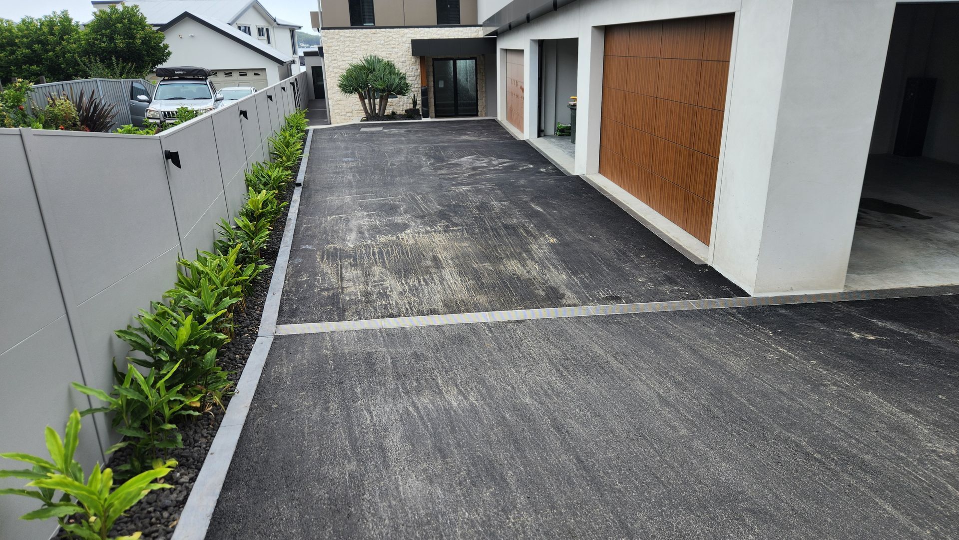 Driveway Leading to a Modern Building With a Garage — TAC Asphalt Services in Warners Bay, NSW