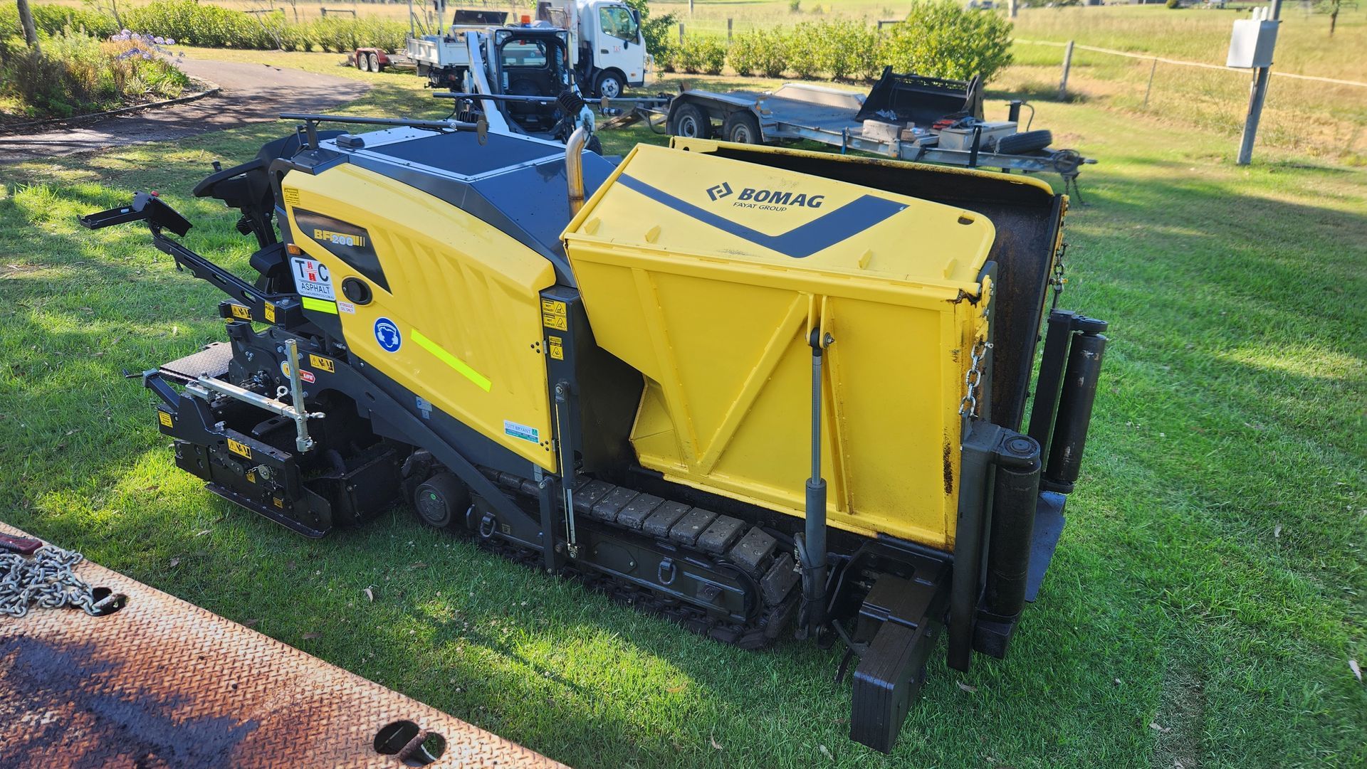 Yellow And Black Trencher Machine On Tracks — TAC Asphalt Services in Warners Bay, NSW