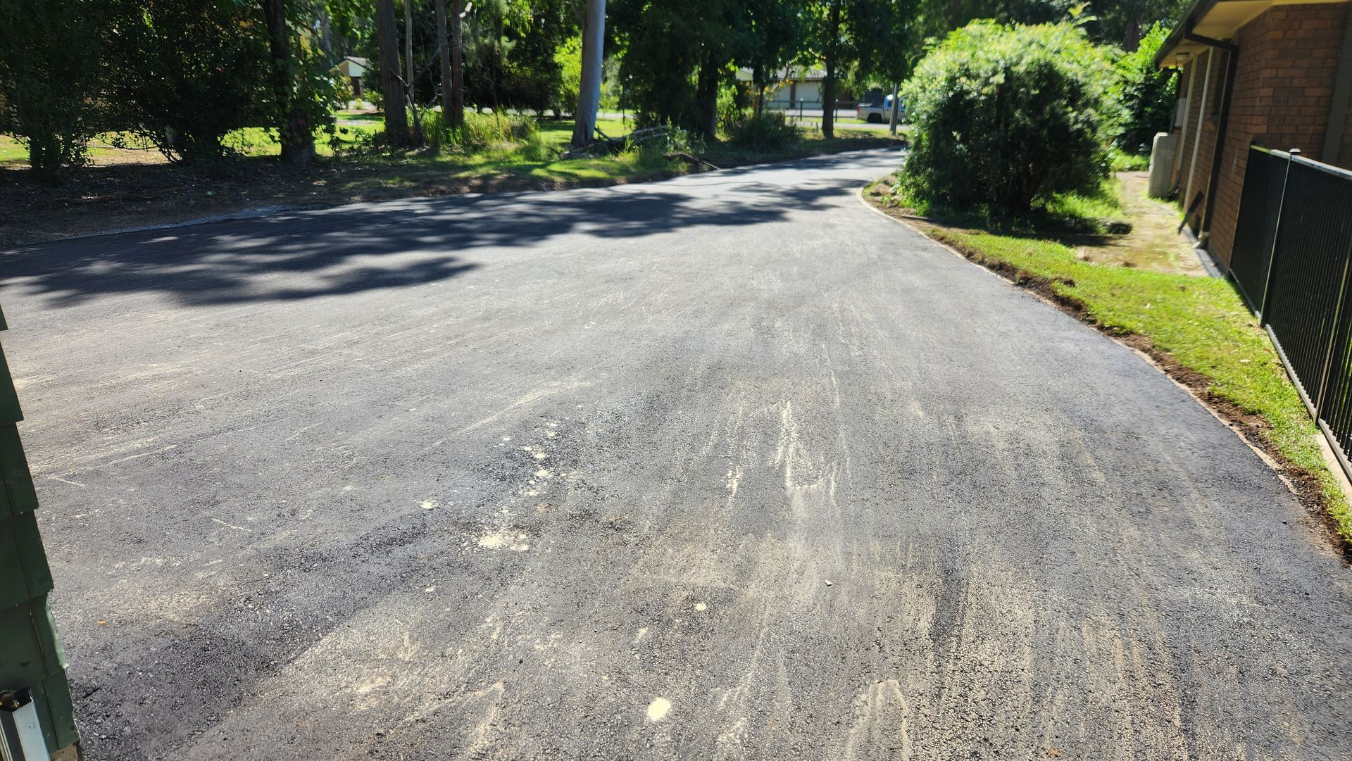 Asphalt Driveway Leading Towards A Residential Street — TAC Asphalt Services in Warners Bay, NSW