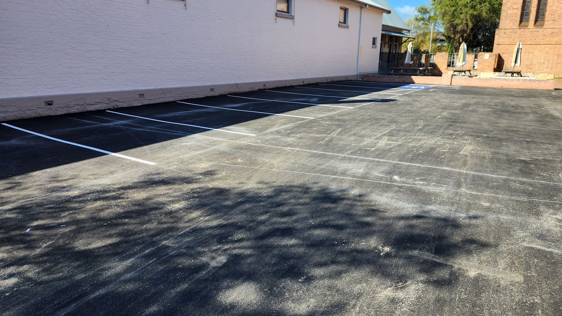 Asphalt Parking Lot With White Parking Space — TAC Asphalt Services in Warners Bay, NSW
