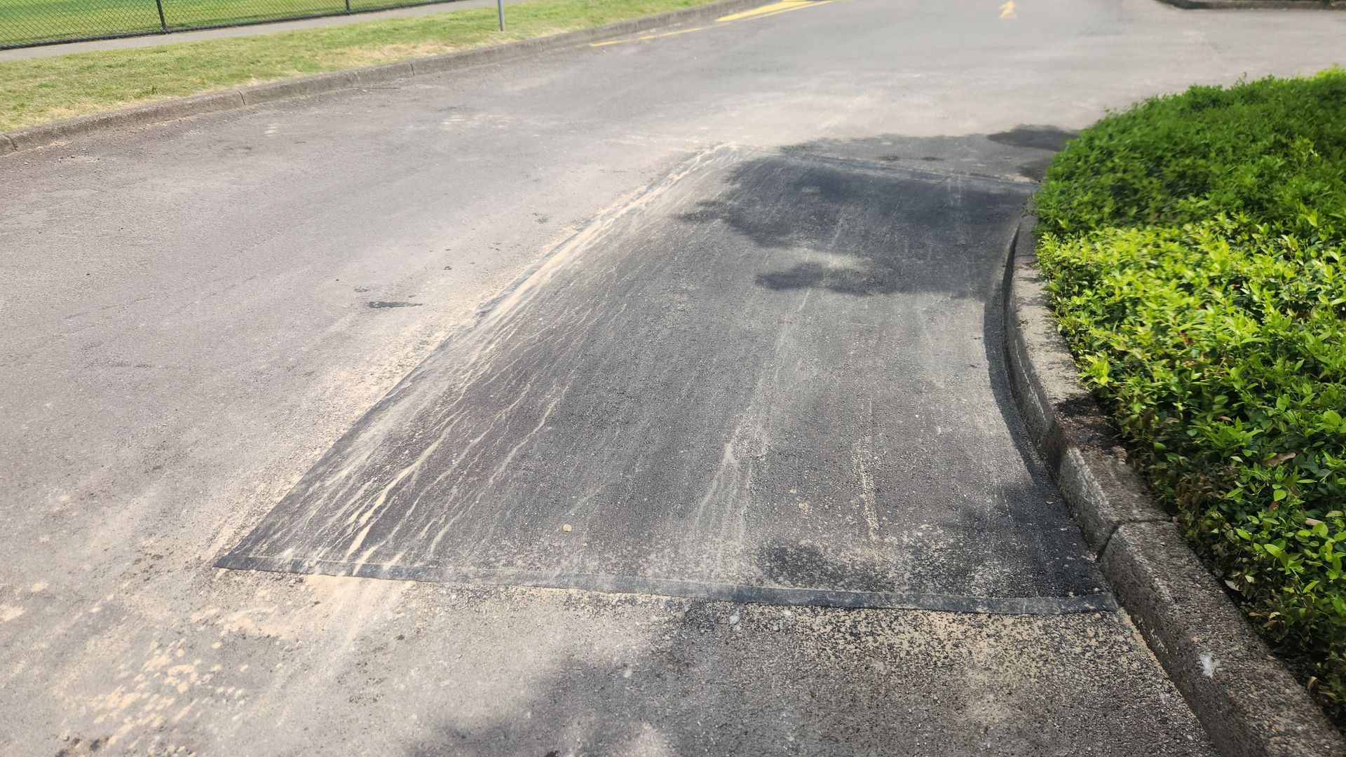 Asphalt Road Patch With Light-colored Splatter — TAC Asphalt Services in Warners Bay, NSW