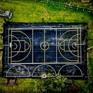 Aerial View Of A Black Basketball Court With White And Yellow Lines — TAC Asphalt Services in Warners Bay, NSW