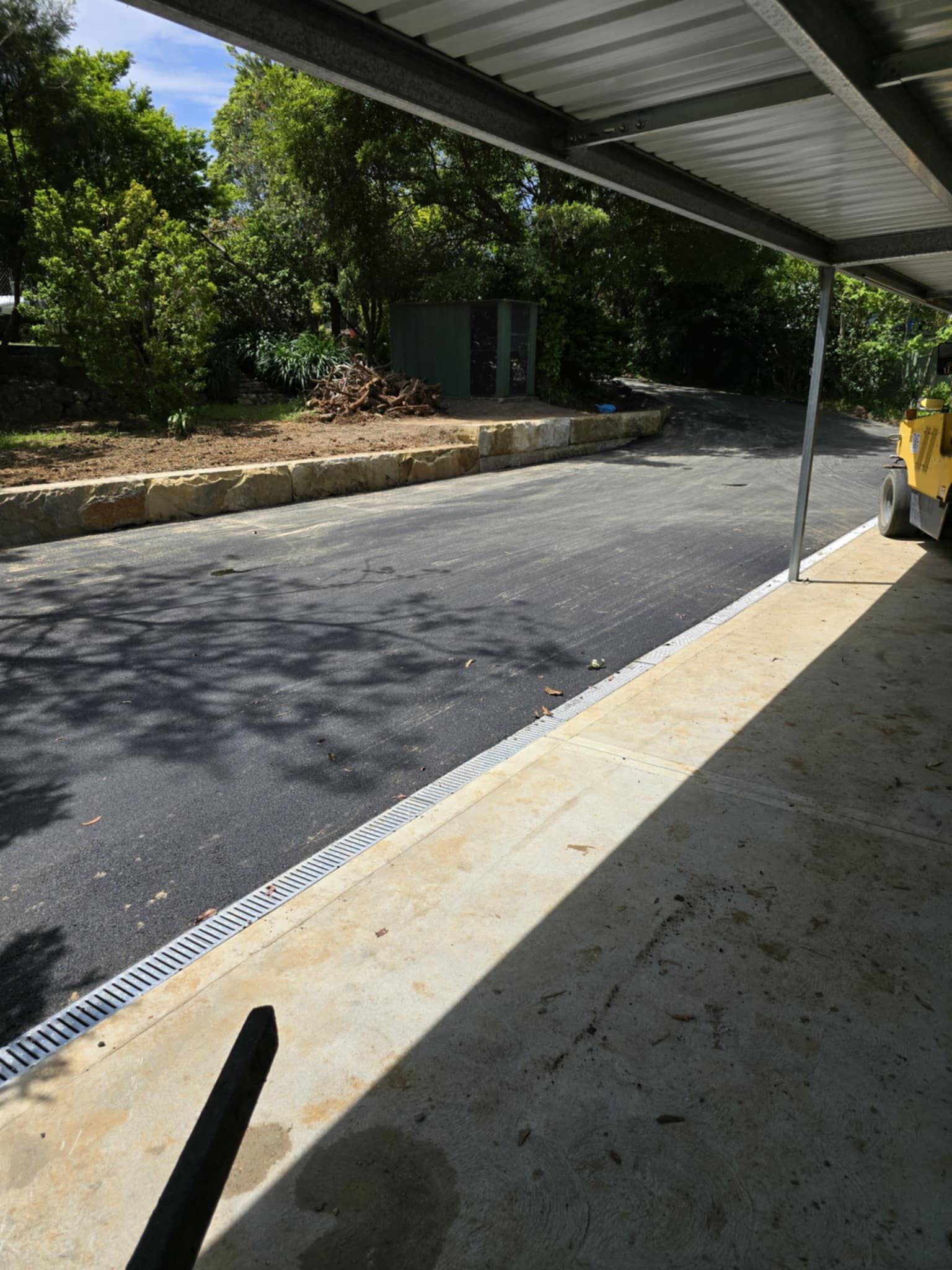 Asphalt Driveway Under A Covered Carport — TAC Asphalt Services in Warners Bay, NSW