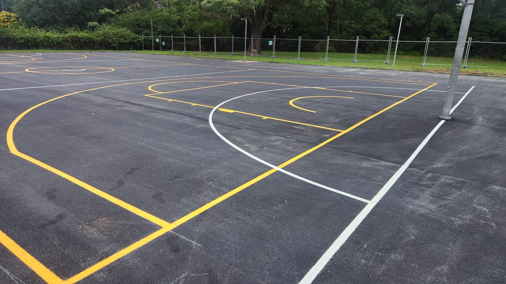 Asphalt Playground With Painted Yellow And White Lines For Various Games — TAC Asphalt Services in Warners Bay, NSW