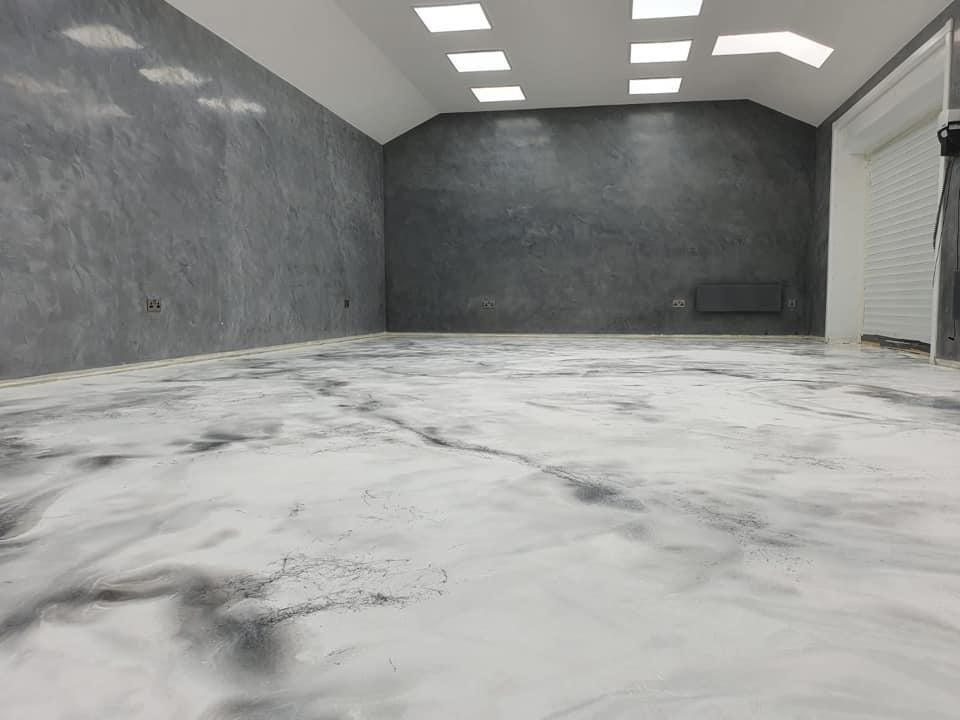 a large empty room with a marble floor and walls .