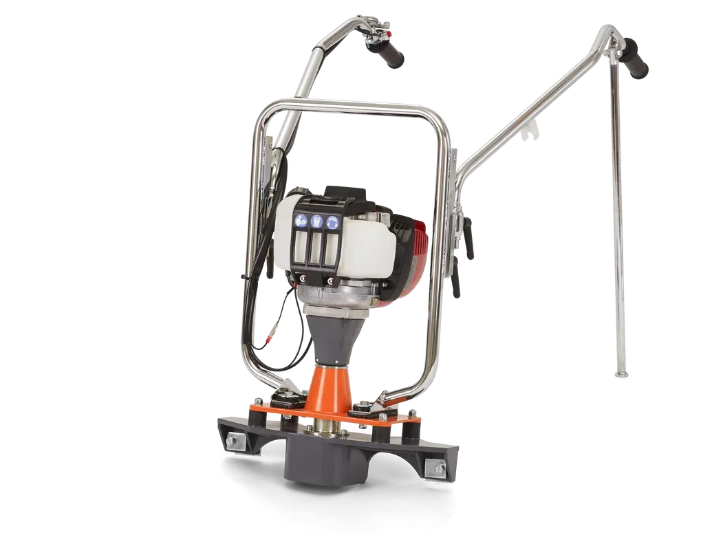 A machine with a motor attached to it is sitting on a white surface.