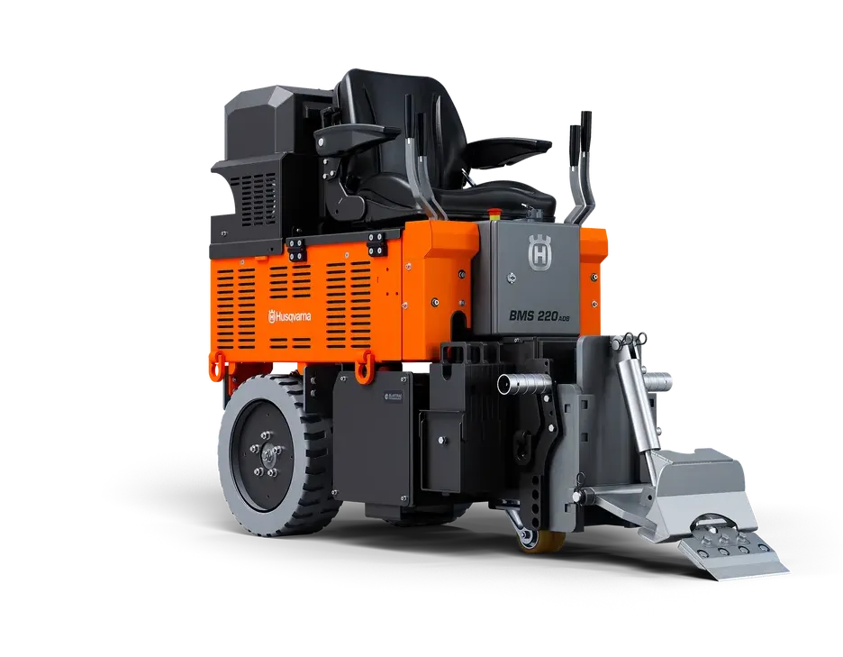 A machine that looks like a tractor is sitting on a white surface.